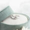Sterling silver "I Am Charlie" tribute ring with cross, honoring Charlie Kirk, in a green velvet ring box with white flowers.
